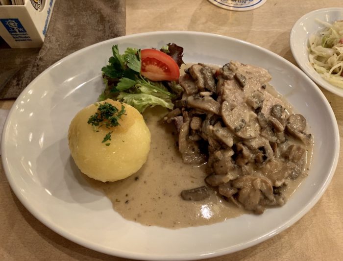 Pork cutlets with a creamy mushroom sauce, paired with a potato dumpling.