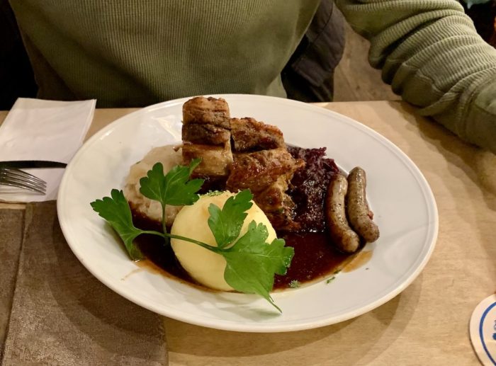 Pork knuckles with homemade sausage and a potato dumpling.